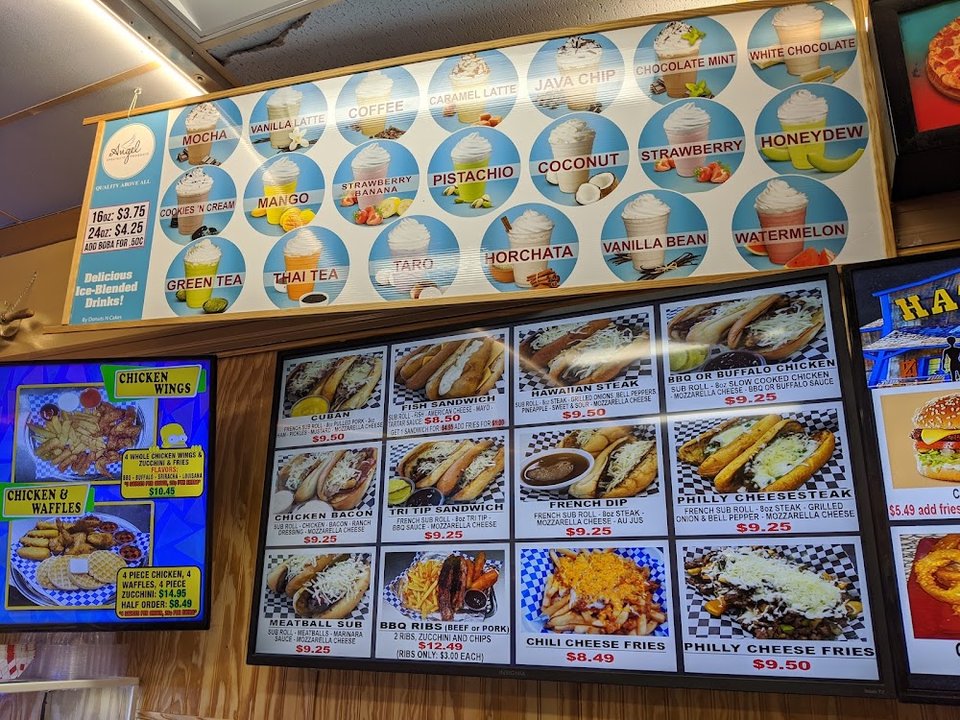 Counter menu showing donuts and sandwiches.